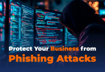 Hooded figure at a computer with code and text saying 'Protect Your Business from Phishing Attacks', illustrating phishing threat and cybersecurity.